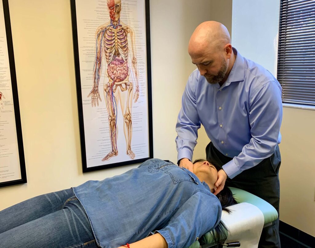 Dr. White performing a cervical spine Chiropractic adjustment.