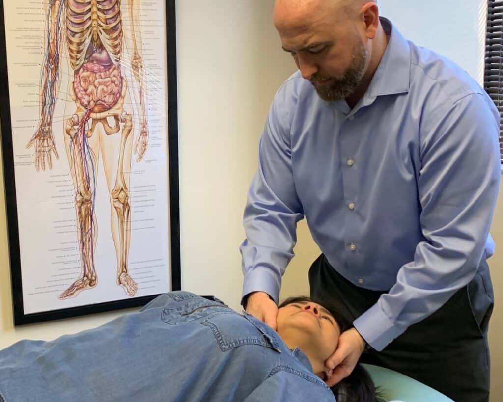 Dr. White Adjusting the cervical spine at Chiropractic and Rehabilitation of Miami Lakes.
